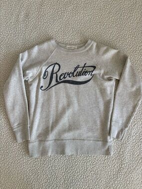 Isabel Marant Étoile grey sweatshirt with “Revolution” graphic.